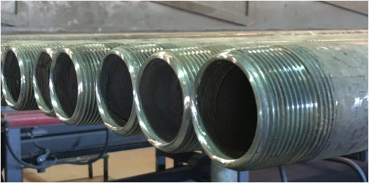OCTG Pipe- IPC application process. Pipe is blasted, burned out and primed for IPC.